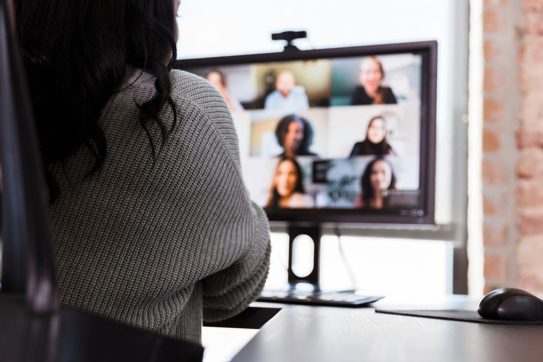Unrecognizable businesswoman participating in virtual staff meeting